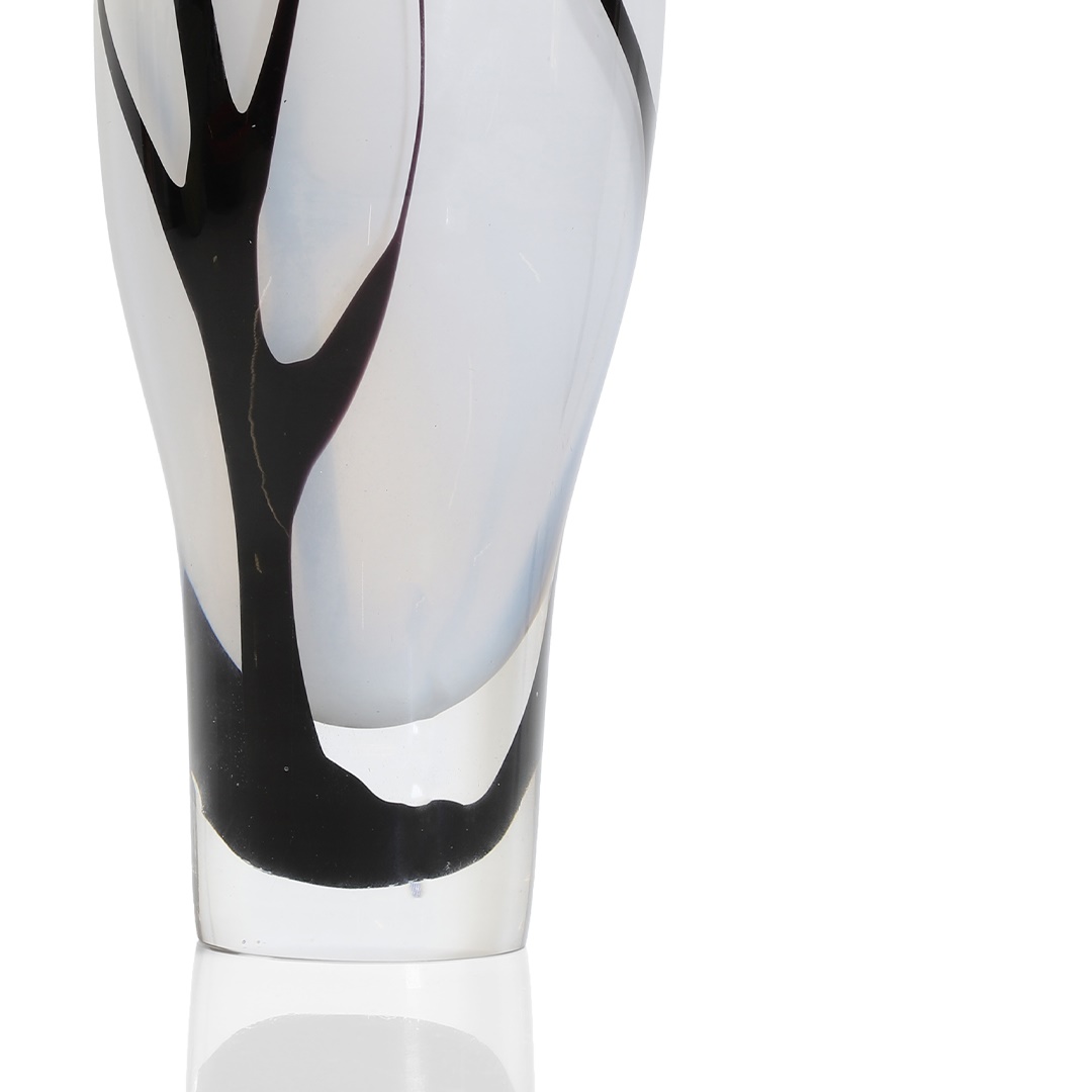 Vicke Lindstrand (Swedish, 1904-1983) a 'Träd i dimma' (Trees in fog) glass vase, designed in 1951 for Kosta, the clear crystal underlaid with opalescent glass and decorated in black with the outline of trees, signed with acid stamp LIND-STRAND KOSTA and engraved LU 2005 34cm high (£1,000-1,500)